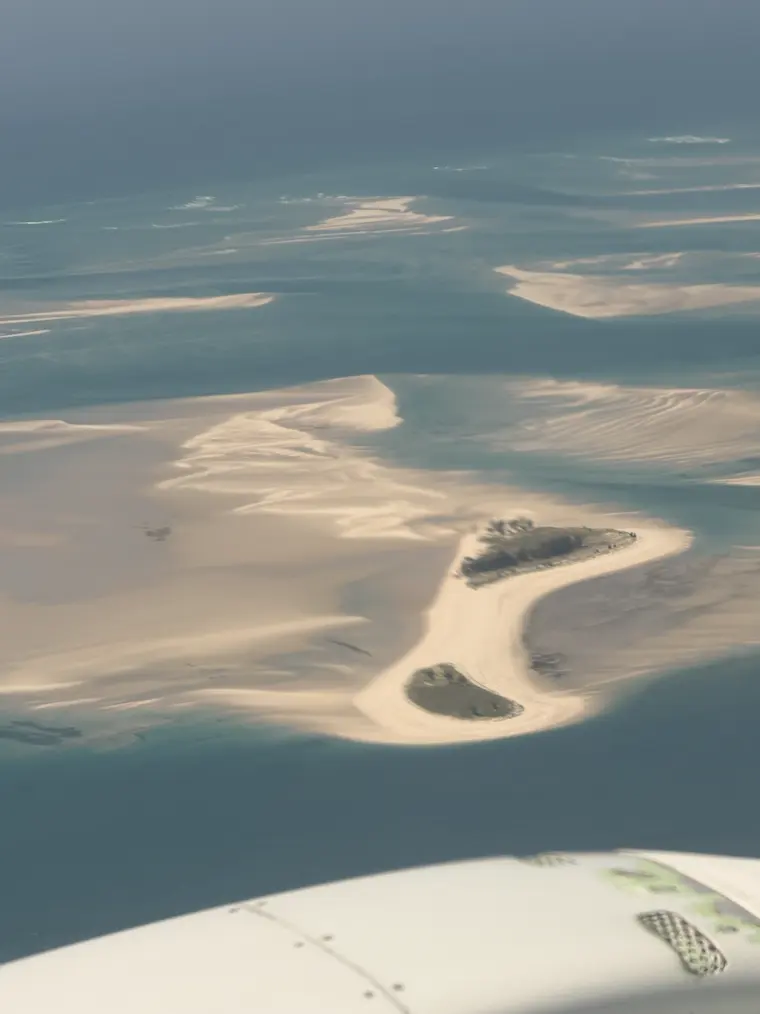 A sand island in the turquoise bay