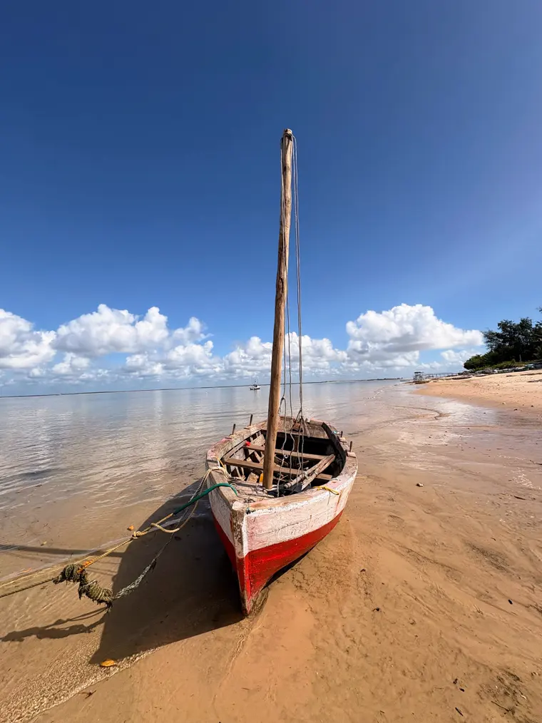 A dhow against the midday clouds