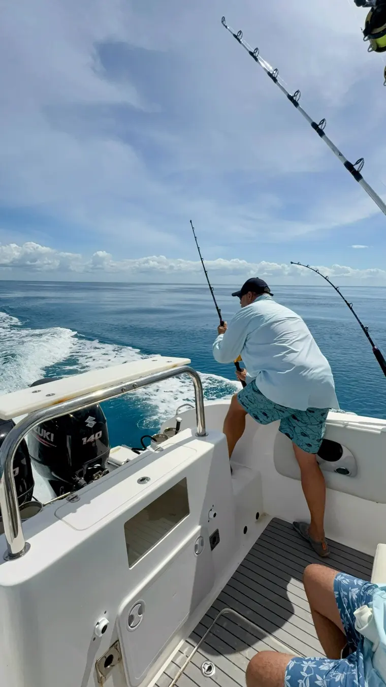 An angler working a fish at the stern