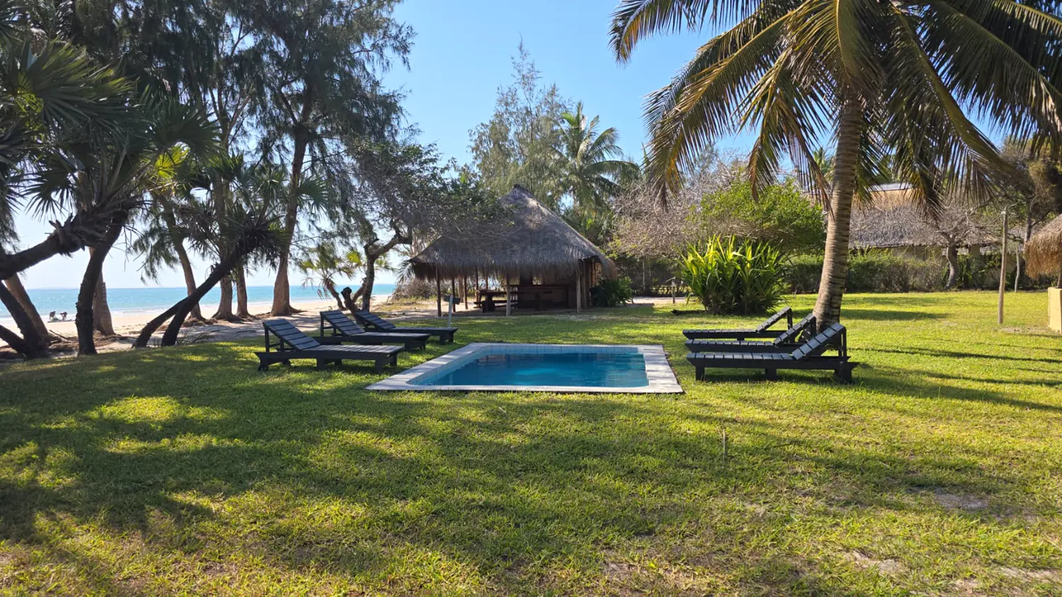 The pool and thatch lapa among the lawns