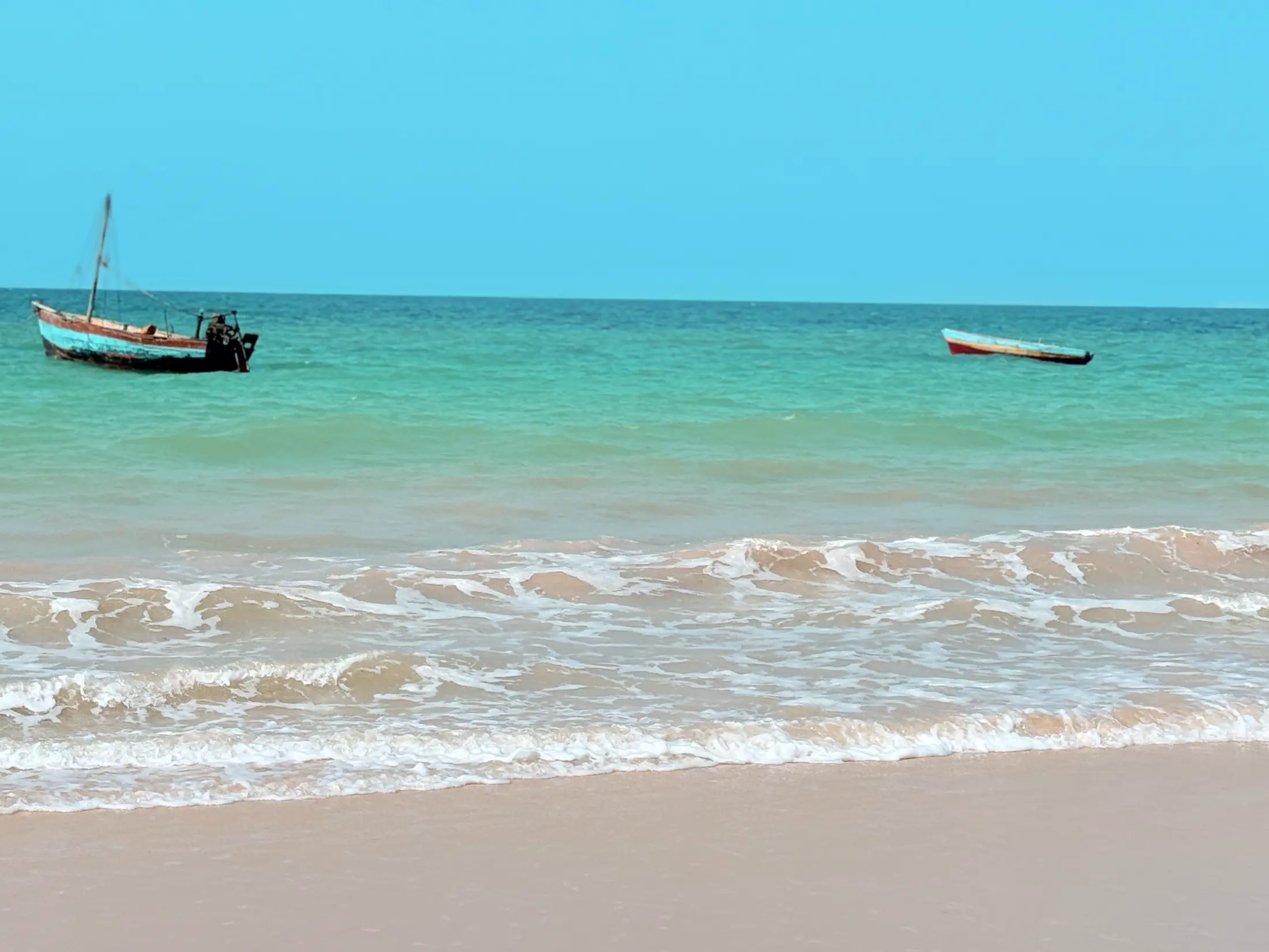 Dhows moored on the turquoise shallows at Inhassoro
