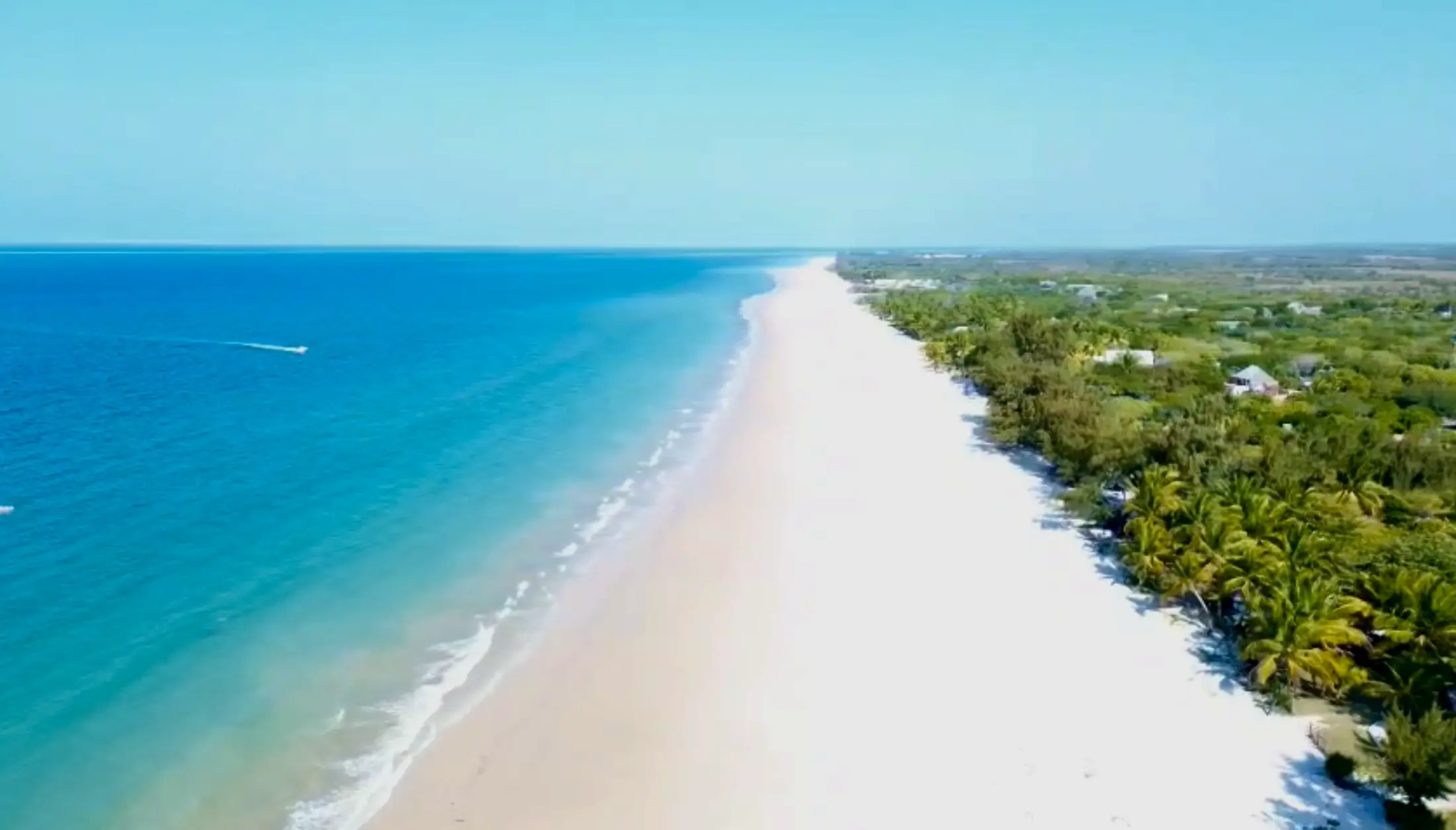 The white beach at Inhassoro from above, turquoise water along the shore