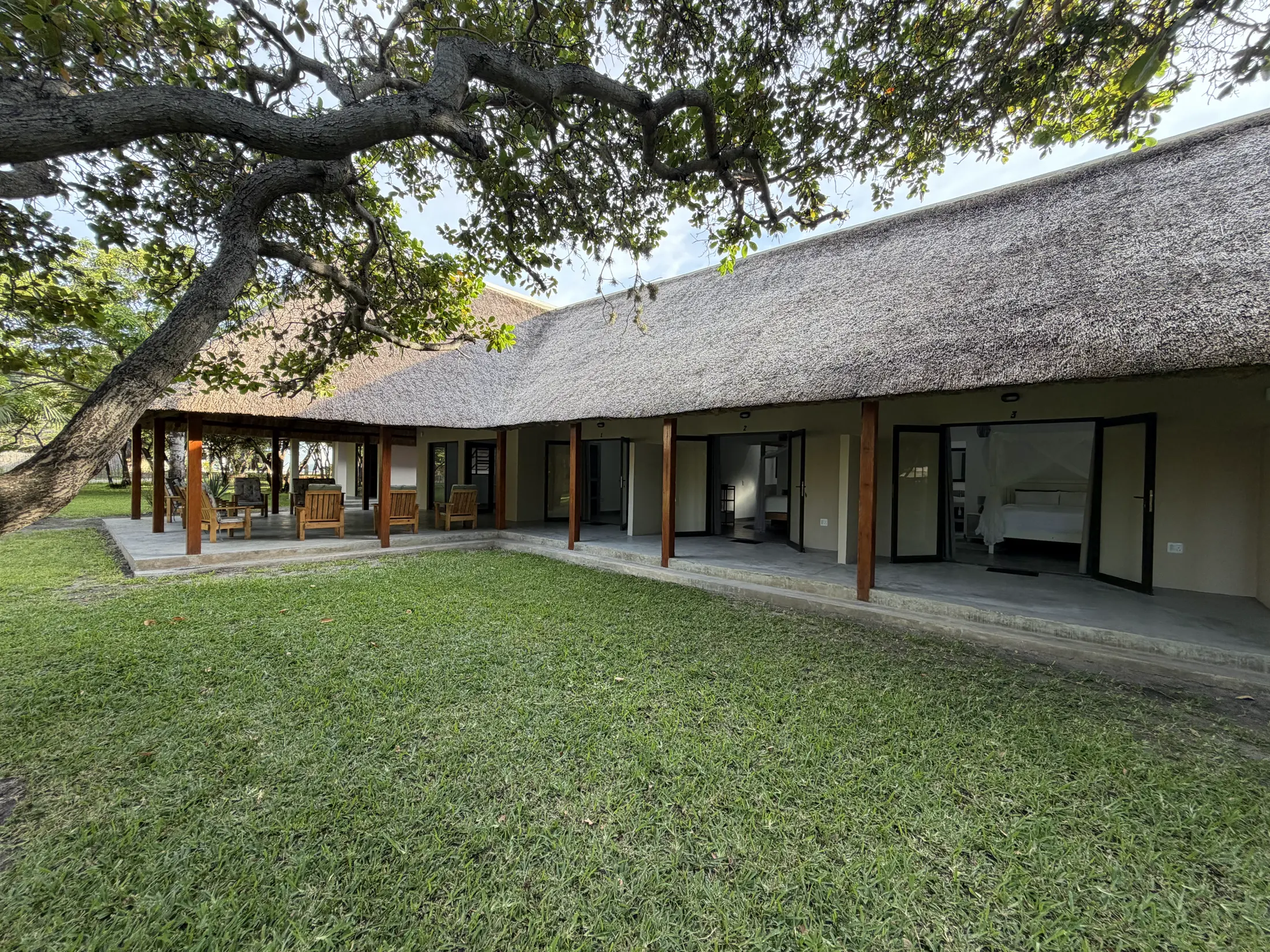 The thatched main lodge seen across its lawns