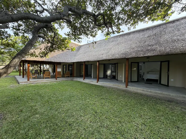The thatched lodge across the lawn