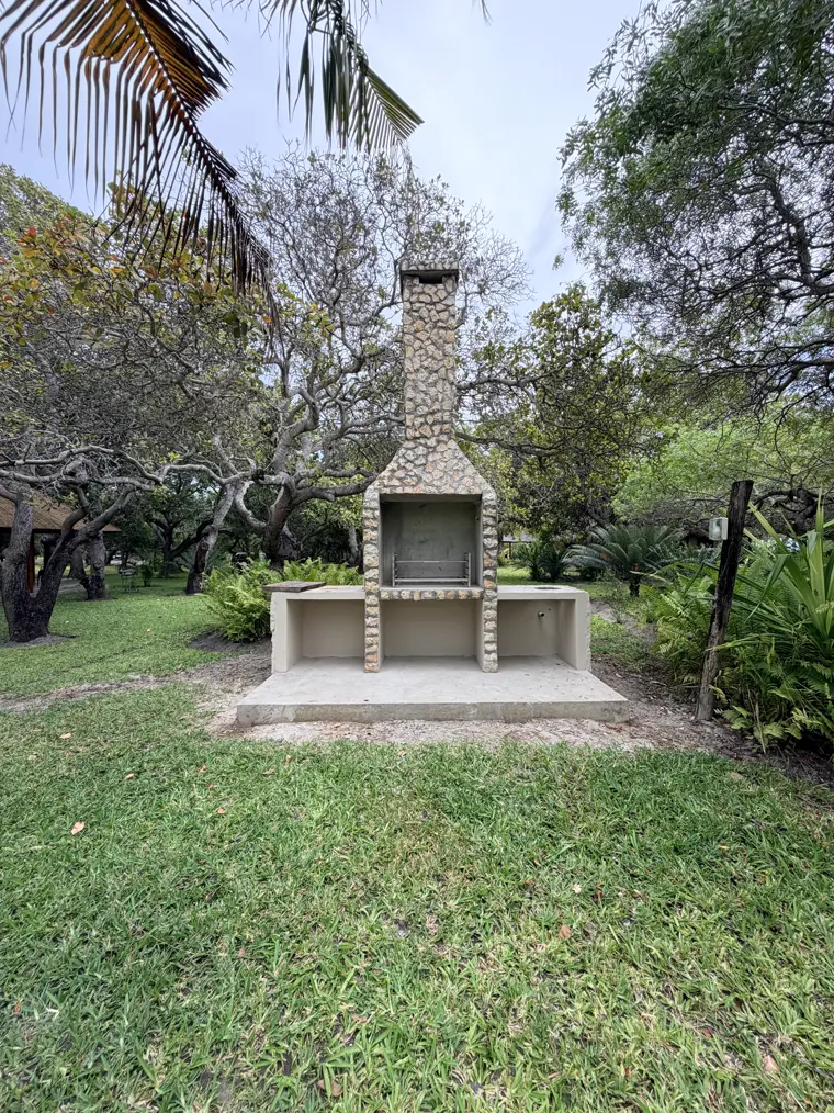 The outdoor fireplace among the trees
