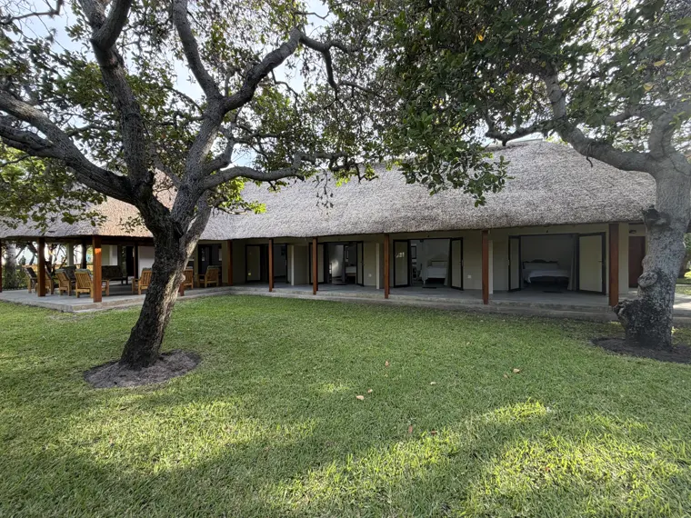 The lodge beneath its big trees