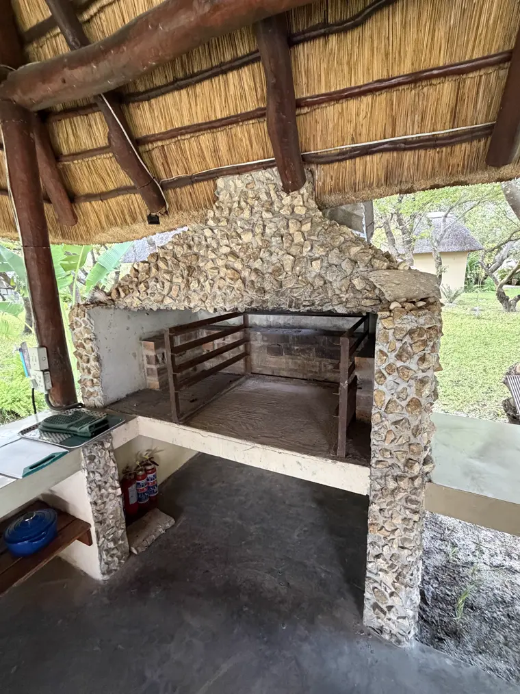 The stone braai under the thatch